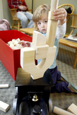 photo of a small boy stacking wooden blocks
